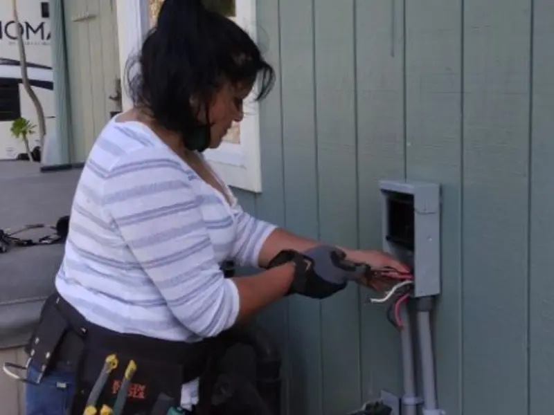 Licensed electrician wiring an exterior subpanel in Rupert